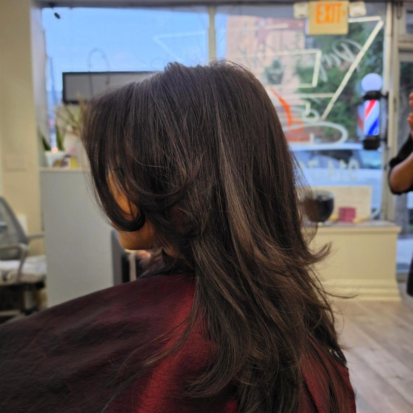 Layered cut with curtain bangs on dark brown hair